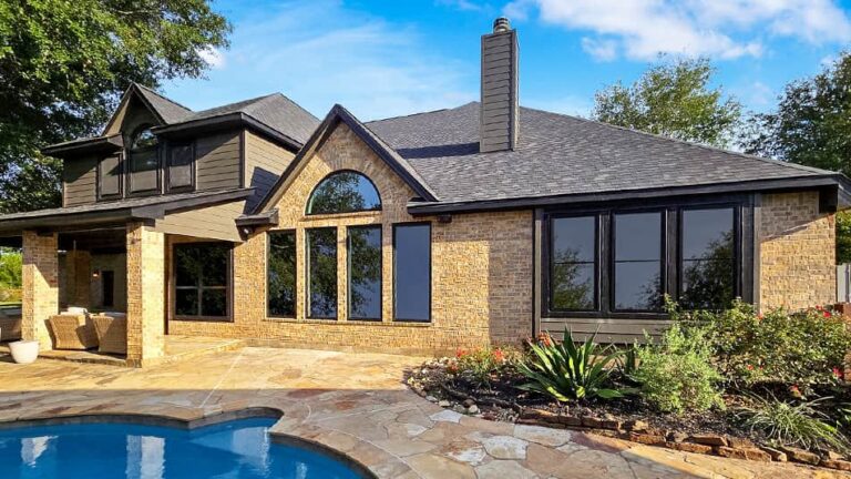 Backyard view with pool of house with windows